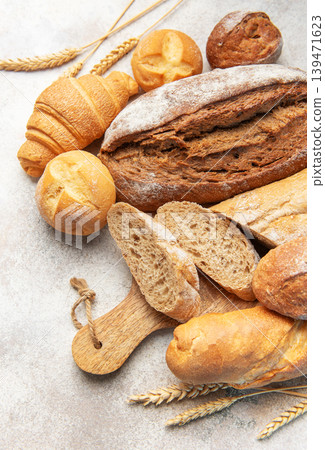 Assorted fresh bakery bread products on textured background Assorted fresh bakery bread products on textured background 139471623