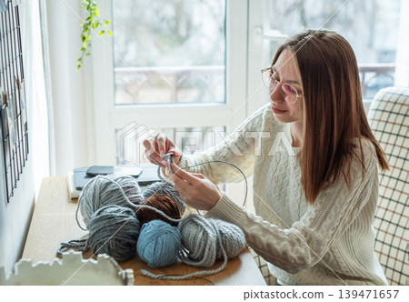 Woman opening a cardboard box Woman opening a cardboard box 139471657