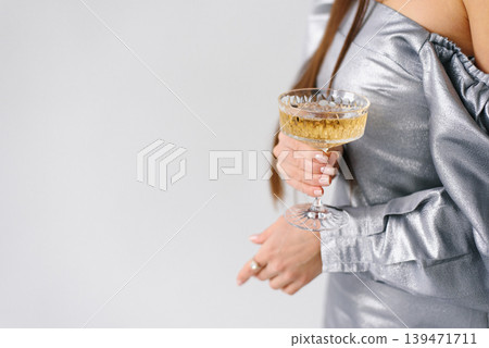 Minimalist Celebration Background With Woman Holding Champagne Coupe Minimalist Celebration Background With Woman Holding Champagne Coupe 139471711