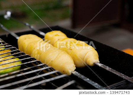 Chopped zucchini and khachapuri roasting on fire seasoned with aroma herbs and spices. Delicious fresh vegetables vegetarian grilling on barbecue smoker grid. Diet vegan bbq. Outdoor recreation Chopped zucchini and khachapuri roasting on fire seasoned with aroma herbs and spices. Delicious fresh vegetables vegetarian grilling on barbecue smoker grid. Diet vegan bbq. Outdoor recreation 139471743