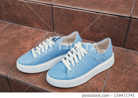 Elegant blue leather womens shoes blank product for branding displayed. New casual female sneakers no-brand footwear e-commerce. No logo product unbranded fashion Elegant blue leather womens shoes blank product for branding displayed. New casual female sneakers no-brand footwear e-commerce. No logo product unbranded fashion 139471745