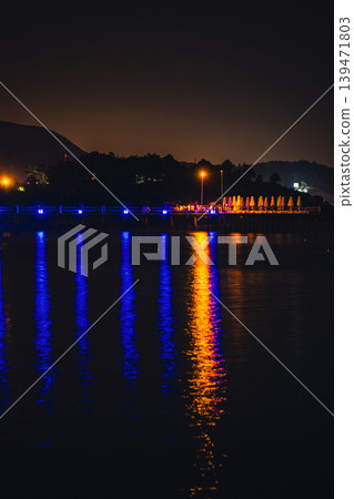Moonlight Over Sea Waves Full Moon Glow ocean waves on sandy beach at night wooden pier. The moon illuminates water surface. Concept of beach vacation slowing down on seacoast 139471803