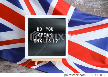 Message DO YOU SPEAK ENGLISH on background of Great Britain UK flag. British national flag with concept of High school university college education, language courses, online distance learning Message DO YOU SPEAK ENGLISH on background of Great Britain UK flag. British national flag with concept of High school university college education, language courses, online distance learning 139471812