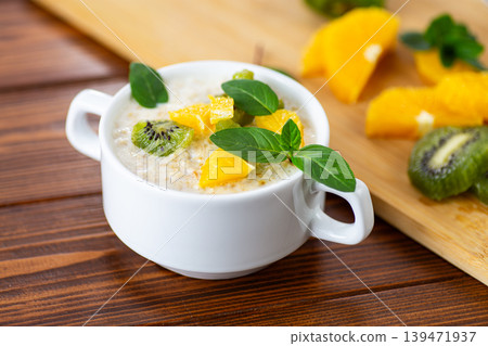 Fresh homemade porridge with citrus fruits and green kiwi Fresh homemade porridge with citrus fruits and green kiwi 139471937