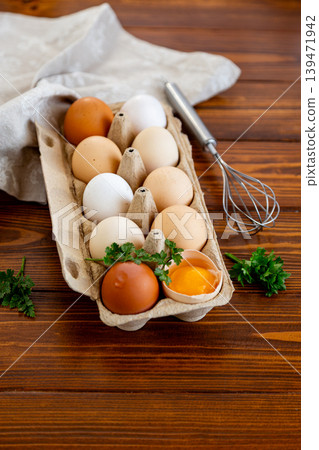 Organic chicken eggs with broken shell and kitchen utensil closeup Organic chicken eggs with broken shell and kitchen utensil closeup 139471942