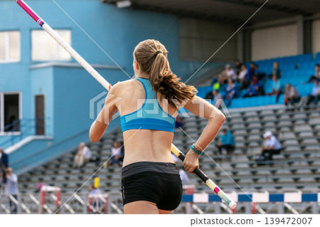 Runway female athlete with pole in hands Runway female athlete with pole in hands 139472007