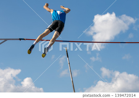 Male athlete flying on background blue sky Male athlete flying on background blue sky 139472014
