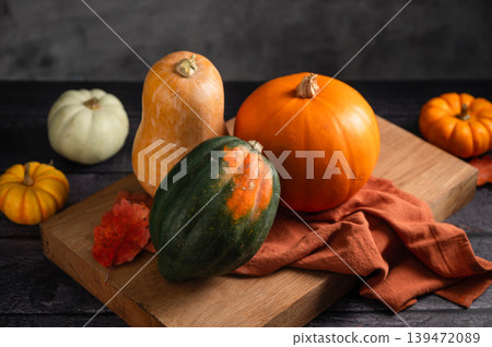 Orange pumpkins, dark moody background, autumn concept Orange pumpkins, dark moody background, autumn concept 139472089