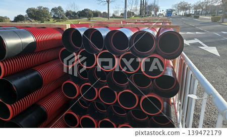 Stacked drainage pipes on roadside for construction background and utility installation banner for road repair projects Stacked drainage pipes on roadside for construction background and utility installation banner for road repair projects 139472179