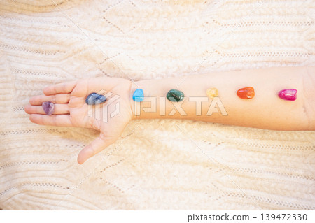 Healing crystals on female hand background, seven chakra stones 139472330