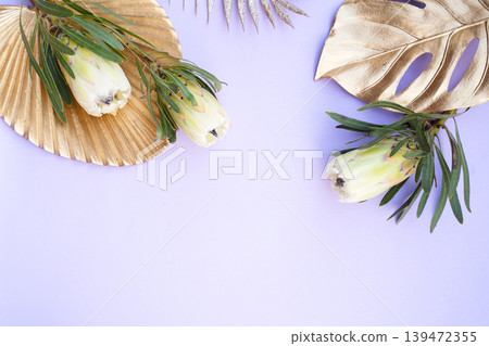 Tropical leaves and flowers over green background, summer background with copy space Tropical leaves and flowers over green background, summer background with copy space 139472355