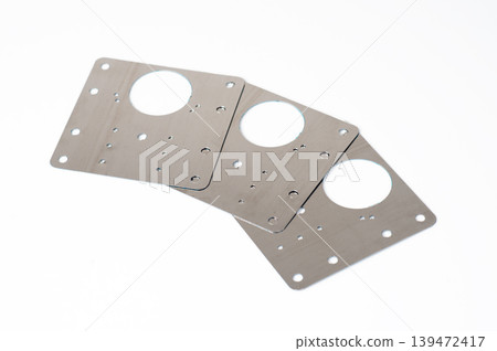 Three stainless steel cabinet hinge repair plates for fixing broken furniture doors, isolated on white background. Three stainless steel cabinet hinge repair plates for fixing broken furniture doors, isolated on white background. 139472417