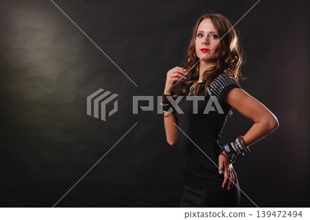 woman with jewellery in black evening dress woman with jewellery in black evening dress 139472494