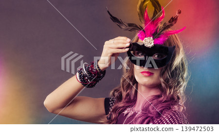 Woman with carnival venetian mask on dark Woman with carnival venetian mask on dark 139472503