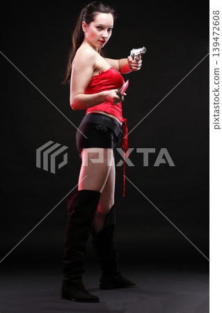 Sexy young woman - gun on black background Sexy young woman - gun on black background 139472608