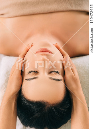 Woman enjoying head massage, face close-up. Relaxing anti-stress massage, treatment head pain Woman enjoying head massage, face close-up. Relaxing anti-stress massage, treatment head pain 139472635