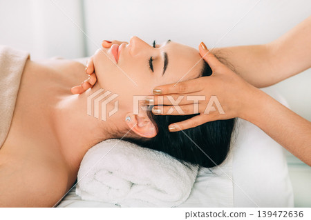 Woman enjoying head massage, face close-up. Relaxing anti-stress massage, treatment head pain Woman enjoying head massage, face close-up. Relaxing anti-stress massage, treatment head pain 139472636
