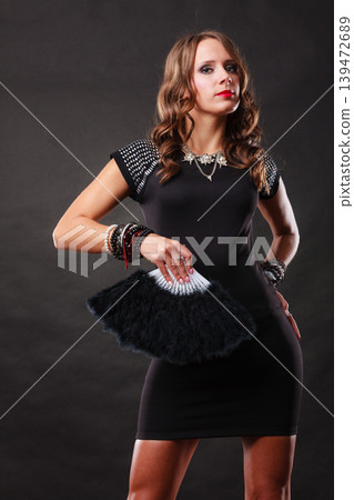 beautiful brunette woman with black fan in hand beautiful brunette woman with black fan in hand 139472689