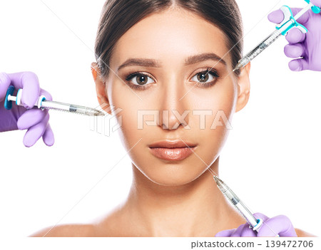 woman advertising concept of lifting skin using beauty injection iasolated on white. lot of syringes around a female face. non-surgical cosmetology 139472706