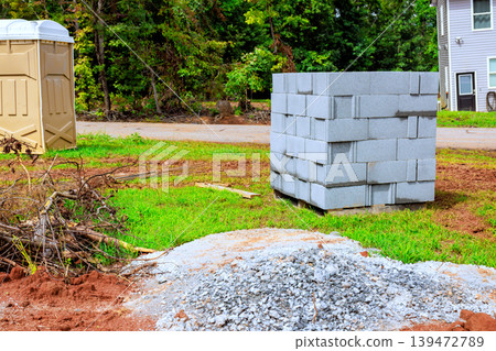 Workers are getting ready to use blocks gravel for construction project at site Workers are getting ready to use blocks gravel for construction project at site 139472789
