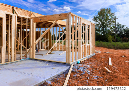 Workers are building wooden frame beams structure in construction work area 139472822