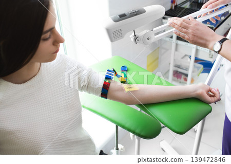 venous blood sampling for analysis. The nurse view the patient veins with the help of a special Vein scanner 139472846