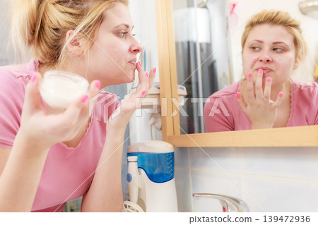 Woman applying face cream with her finger 139472936