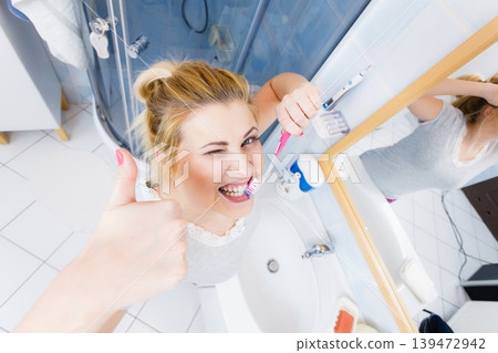 Woman brushing cleaning teeth in bathroom 139472942