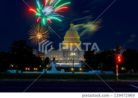 Fireworks burst at Independence Day over United States Capitol building, marking festive occasion in Washington, DC city. 139472969