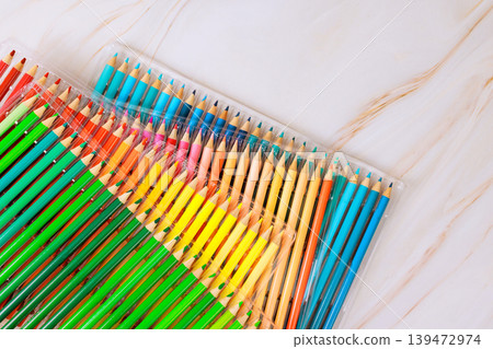 Colored pencils in clear package sit on smooth surface, ready for drawing, crafting, school projects. Colored pencils in clear package sit on smooth surface, ready for drawing, crafting, school projects. 139472974