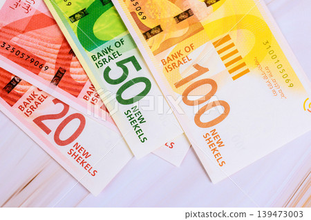 Various denominations of new Israeli shekels are laid out 20, 50, 100 bills. Various denominations of new Israeli shekels are laid out 20, 50, 100 bills. 139473003