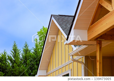 New yellow house its roof sides with edges gutters under construction process 139473005