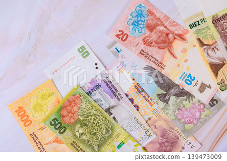 Different Argentine pesos banknotes in various amounts are spread issues central Bank Argentina Different Argentine pesos banknotes in various amounts are spread issues central Bank Argentina 139473009