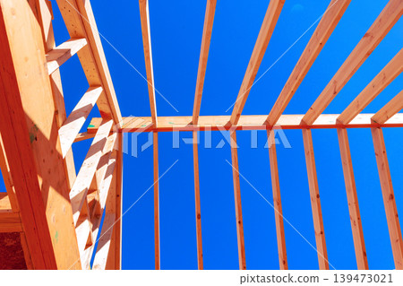 Workers install wooden beams for trusses structure building under construction project 139473021