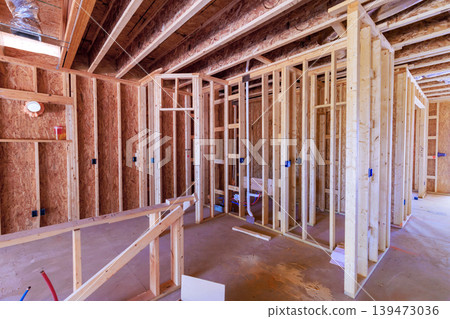 Workers build wooden beams frame walls at construction site where house is taking shape new home Workers build wooden beams frame walls at construction site where house is taking shape new home 139473036