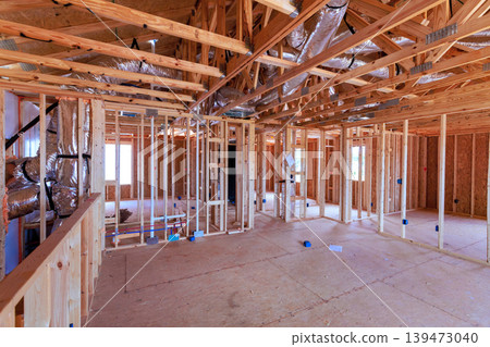 Workers build beams structure of house with wooden frames open spaces Workers build beams structure of house with wooden frames open spaces 139473040
