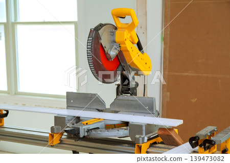 Saw is positioned on workstation in awork area tool materials are nearby as preparation for cutting begins. Saw is positioned on workstation in awork area tool materials are nearby as preparation for cutting begins. 139473082