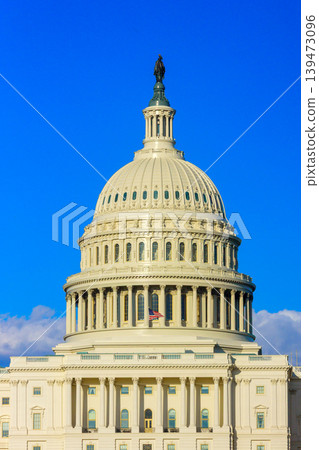 The dome of the Capitol building is visible with clear sky and few clouds on a sunny day in Washington D.C. The dome of the Capitol building is visible with clear sky and few clouds on a sunny day in Washington D.C. 139473096