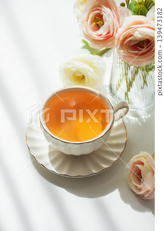 Green Tea Cup with Ranunculus Flowers on White Table Green Tea Cup with Ranunculus Flowers on White Table 139473182