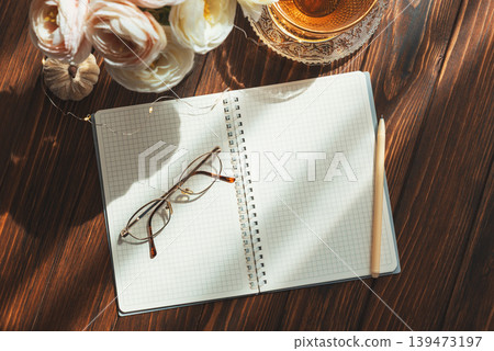 Morning tea, notebook, and ranunculus creating inspiring writing space Morning tea, notebook, and ranunculus creating inspiring writing space 139473197