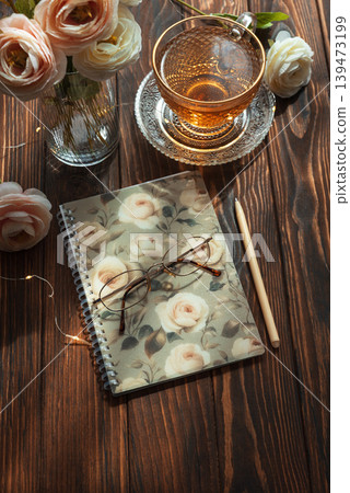 Morning tea, closed notebook, and ranunculus creating inspiring for writing Morning tea, closed notebook, and ranunculus creating inspiring for writing 139473199