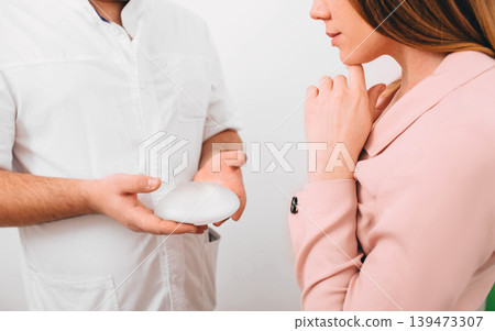breast augmentation. Young woman chooses breast implant breast augmentation. Young woman chooses breast implant 139473307