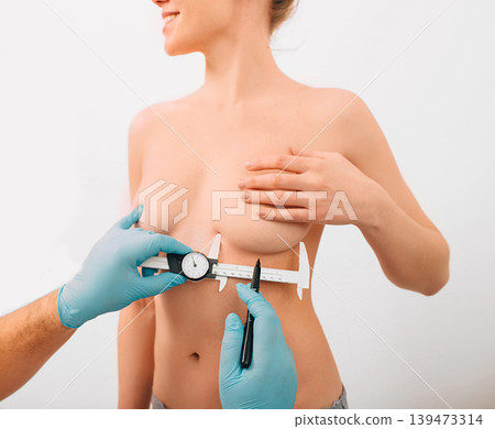 Plastic surgeon marks woman breast for installing breast silicone implant. Cosmetic breast surgery. Plastic surgeon marks woman breast for installing breast silicone implant. Cosmetic breast surgery. 139473314