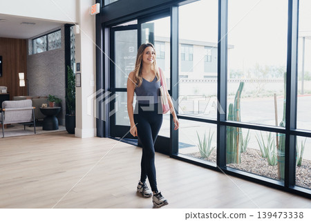 Confident Woman Walking With Skateboard Near Large Windows In Bright Atrium, Approachable Smile, Potted Greenery, Warm Tones And Wellnessoriented Atmosphere, Modern Interior Promoting Active Confident Woman Walking With Skateboard Near Large Windows In Bright Atrium, Approachable Smile, Potted Greenery, Warm Tones And Wellnessoriented Atmosphere, Modern Interior Promoting Active 139473338