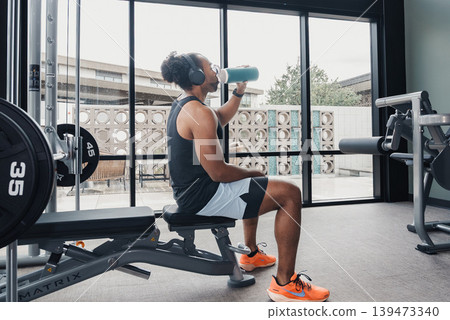 Rehydration Break Activity. Person Drinks Water During Rest Period. Individual Refreshes Themselves During Exercise Pause. Relaxed Person Rehydrates Using Towel During Workout Interval Rehydration Break Activity. Person Drinks Water During Rest Period. Individual Refreshes Themselves During Exercise Pause. Relaxed Person Rehydrates Using Towel During Workout Interval 139473340