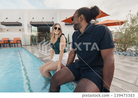 Friends Taking Mindful Pause Poolside, Quiet Relaxation And Slowliving Vibe, Sunglasses And Casual Attire, Soothing Water Reflections, Wellness Moment With Social Connection Friends Taking Mindful Pause Poolside, Quiet Relaxation And Slowliving Vibe, Sunglasses And Casual Attire, Soothing Water Reflections, Wellness Moment With Social Connection 139473383