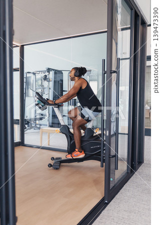 Highintensity Interval Session With Determined Athlete Sweating Profusely. Dedicated Cyclist Pushes Maximum Effort During Rigorous Indoor Training With Concentration And Perspiration Highintensity Interval Session With Determined Athlete Sweating Profusely. Dedicated Cyclist Pushes Maximum Effort During Rigorous Indoor Training With Concentration And Perspiration 139473390