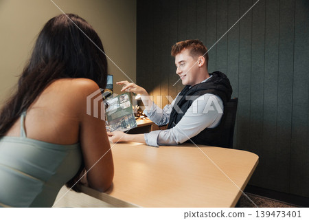 Bartender Pours Whiskey For Female Customer, Intimate Upscale Bar Setting, Man In Vest Carefully Decanting Spirit Into Lowball Glass On Wooden Table, Warm Ambient Lighting, Casual Bartender Pours Whiskey For Female Customer, Intimate Upscale Bar Setting, Man In Vest Carefully Decanting Spirit Into Lowball Glass On Wooden Table, Warm Ambient Lighting, Casual 139473401