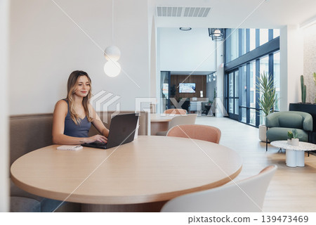 Female Occupant At Spacious Lounge Area. Woman Enjoying Casual Meeting In Bright Atrium Space. Female Individual Seated Comfortably In Open Communal Lounge With Plants And Natural Light Female Occupant At Spacious Lounge Area. Woman Enjoying Casual Meeting In Bright Atrium Space. Female Individual Seated Comfortably In Open Communal Lounge With Plants And Natural Light 139473469