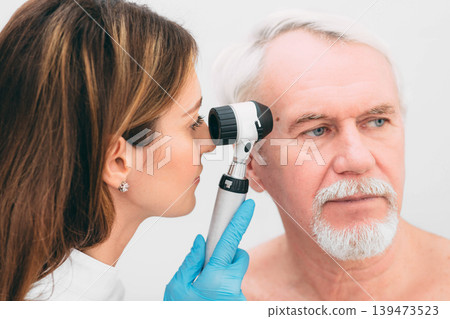 dermatologist Inspecting patient skin moles at clinic dermatologist Inspecting patient skin moles at clinic 139473523